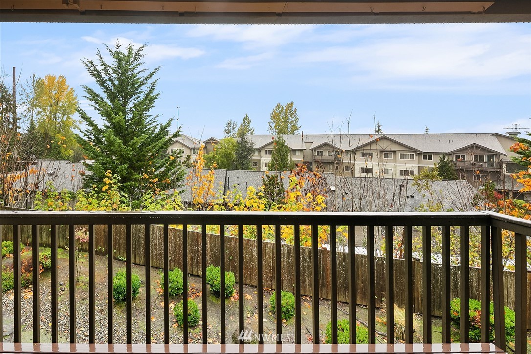 1523 Eagle Ridge Drive South, Unit 1N Renton, WA 98055 - Photo 11 of 21 a view of a balcony with wooden floor and city view