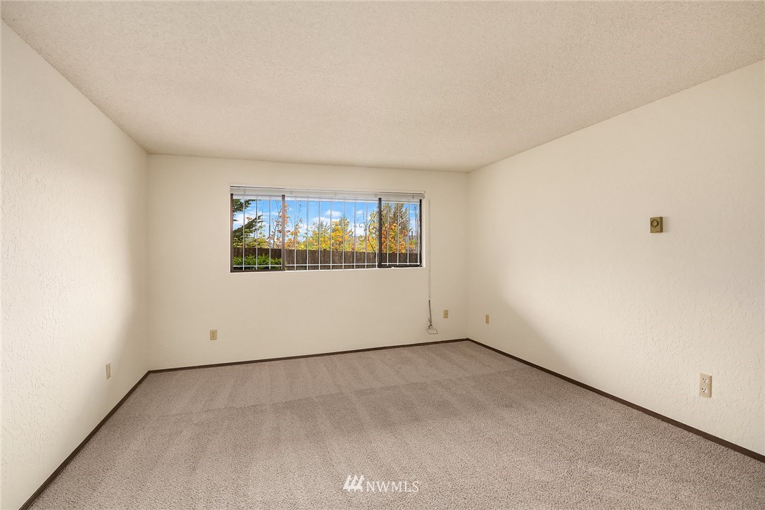 1523 Eagle Ridge Drive South, Unit 1N Renton, WA 98055 - Photo 16 of 21 an empty room with a window