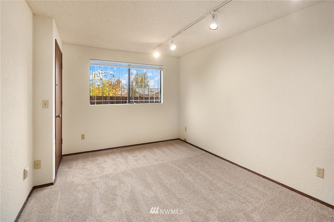 1523 Eagle Ridge Drive South, Unit 1N Renton, WA 98055 - Photo 17 of 21 an empty room with windows