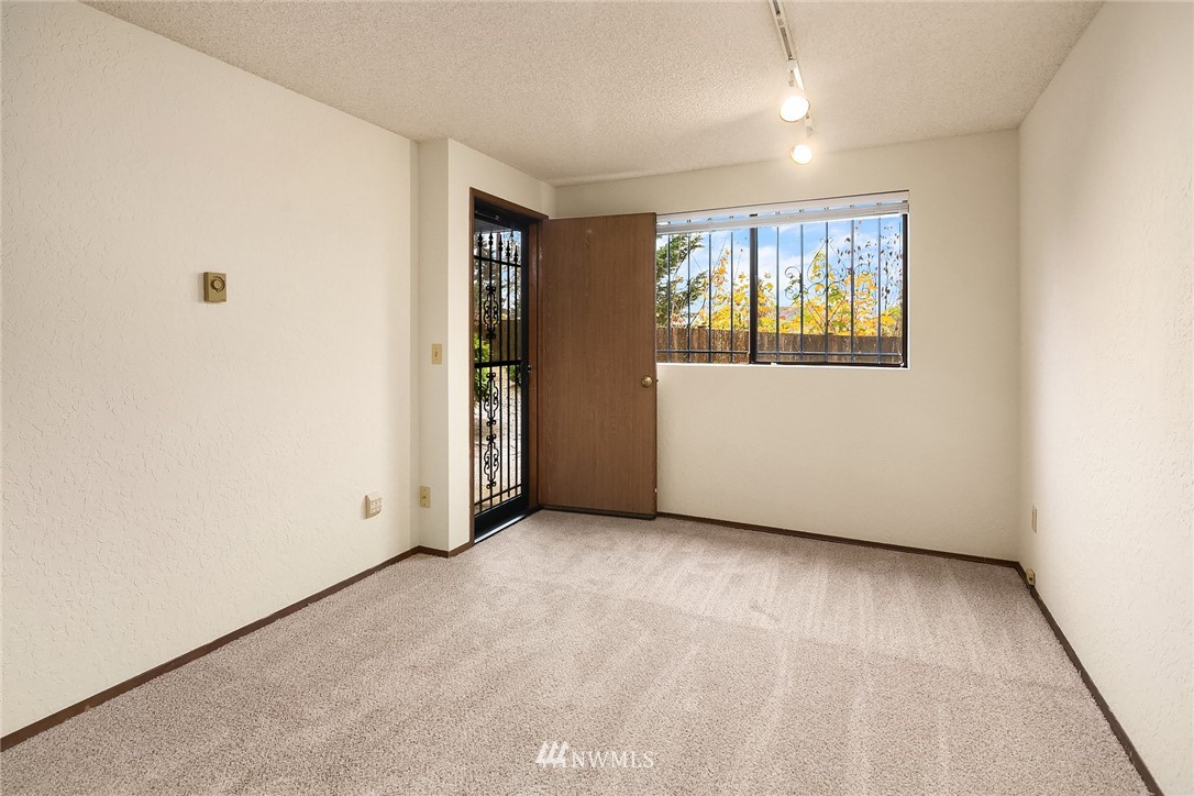 1523 Eagle Ridge Drive South, Unit 1N Renton, WA 98055 - Photo 19 of 21 an empty room with windows
