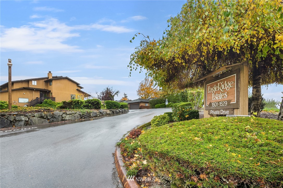 1523 Eagle Ridge Drive South, Unit 1N Renton, WA 98055 - Photo 21 of 21 a view of a house with a big yard and large tree and plants
