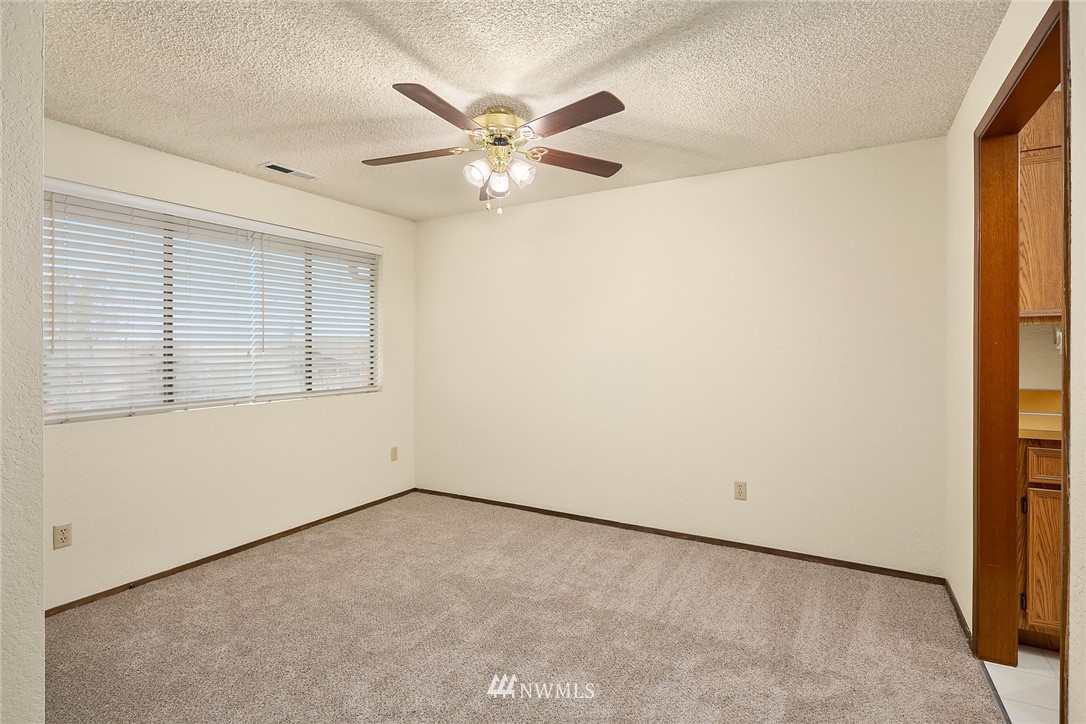 1523 Eagle Ridge Drive South, Unit 1N Renton, WA 98055 - Photo 5 of 21 an empty room with a window and a fan