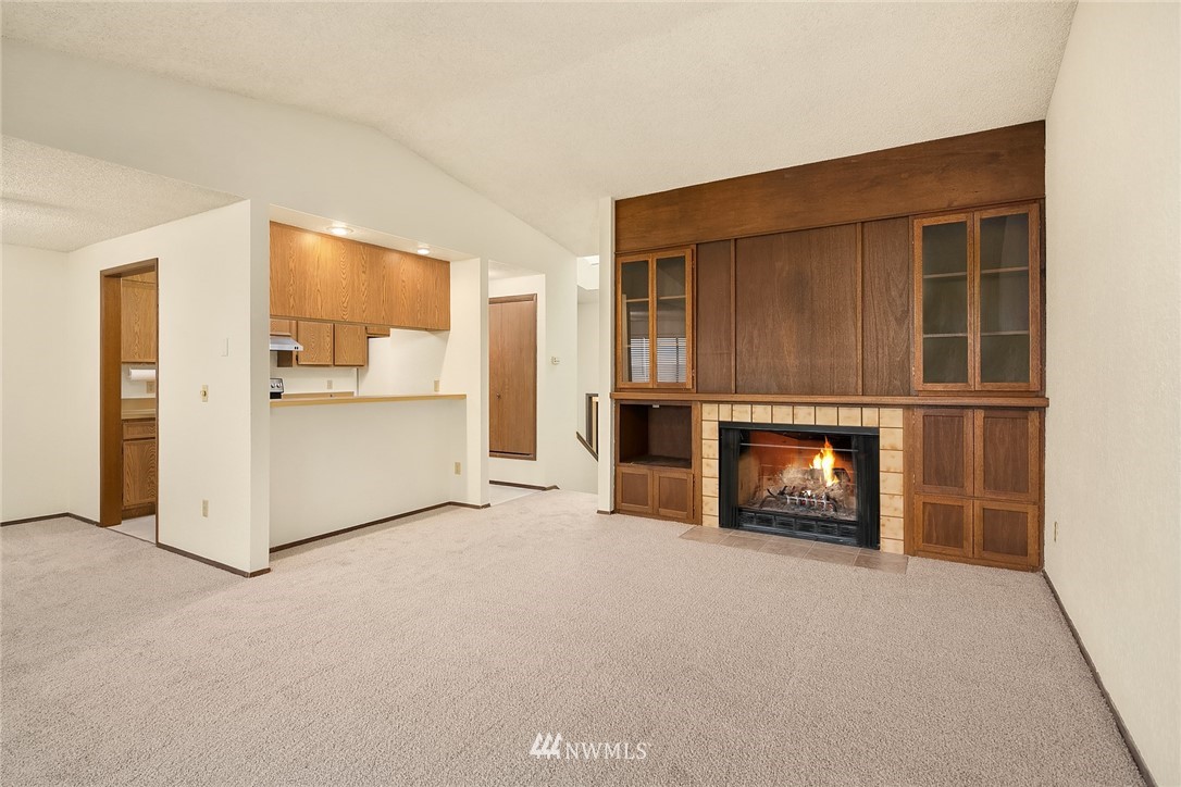 1523 Eagle Ridge Drive South, Unit 1N Renton, WA 98055 - Photo 6 of 21 a view of a livingroom with a fireplace