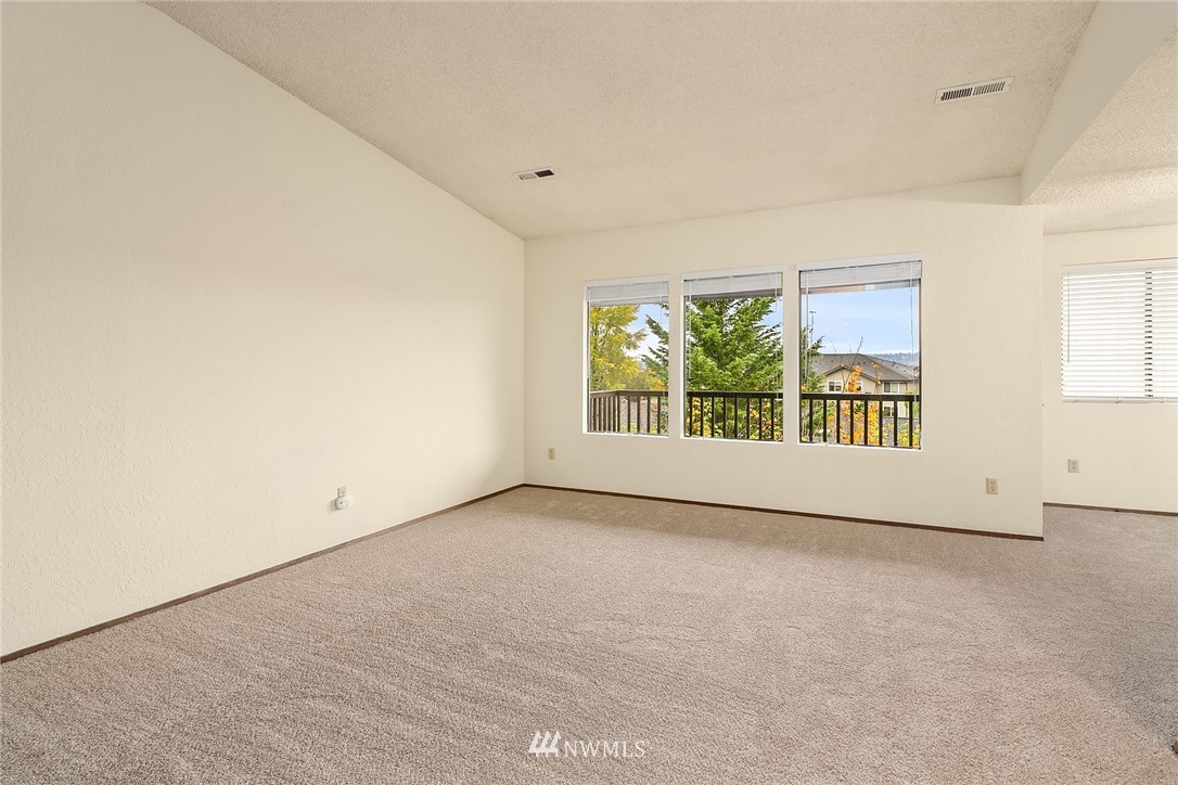 1523 Eagle Ridge Drive South, Unit 1N Renton, WA 98055 - Photo 8 of 21 an empty room with windows