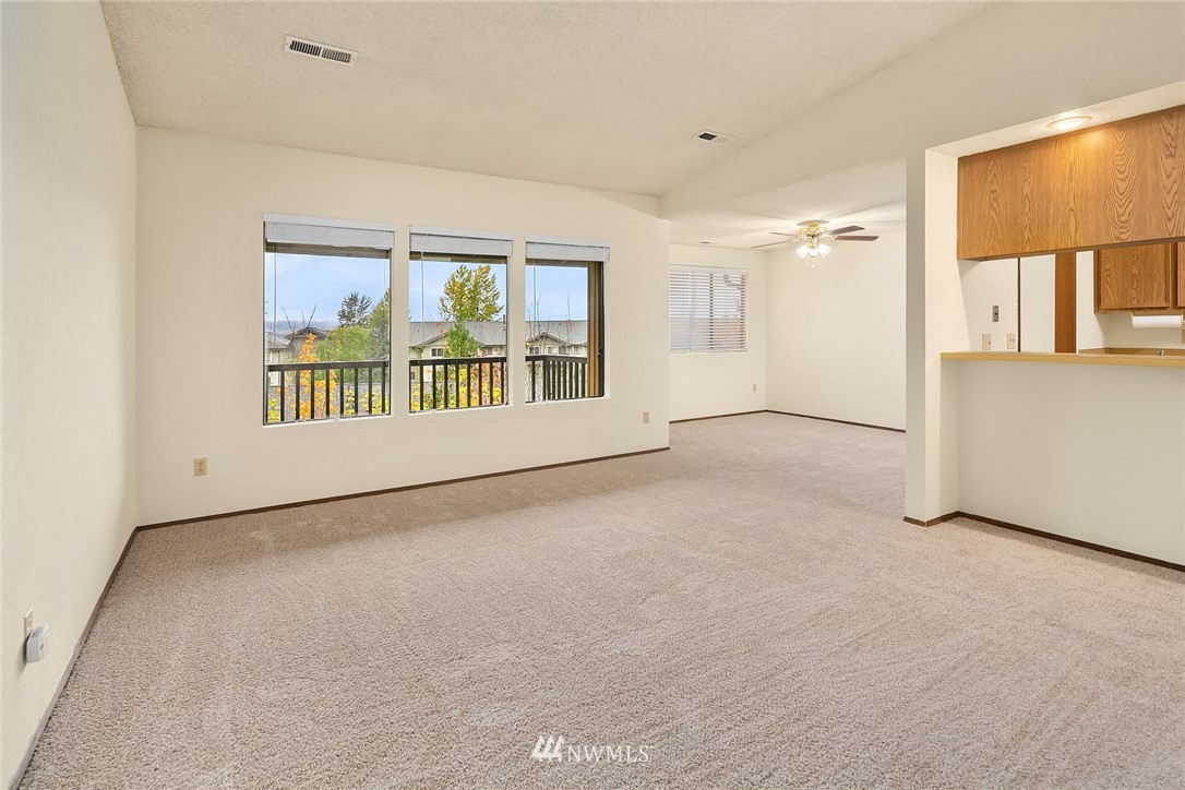 1523 Eagle Ridge Drive South, Unit 1N Renton, WA 98055 - Photo 9 of 21 an empty room with windows