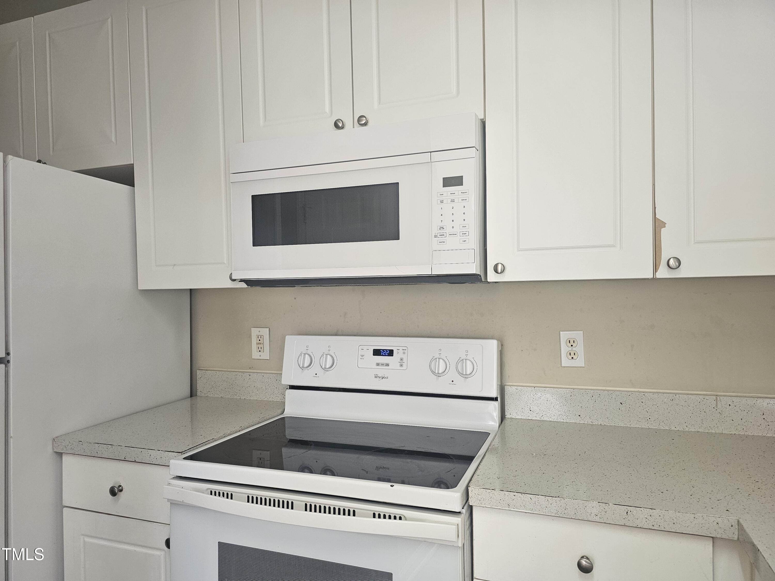 2040 Persimmon Ridge Drive Raleigh, NC 27604 - Photo 28 of 28 a kitchen with white cabinets and white appliances
