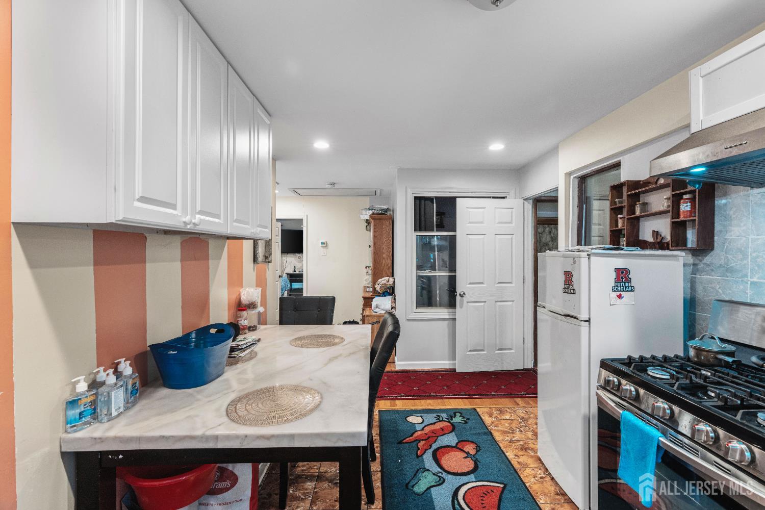247 Adams Street Piscataway, NJ 08854 - Photo 11 of 49 a kitchen with stainless steel appliances granite countertop a sink stove and refrigerator