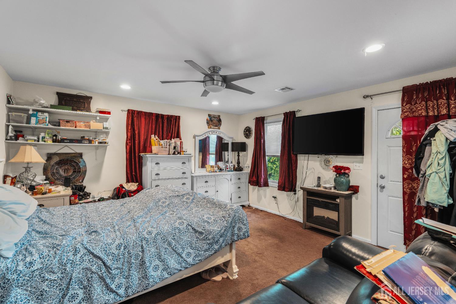 247 Adams Street Piscataway, NJ 08854 - Photo 13 of 49 a bed room with a bed a television and a large window