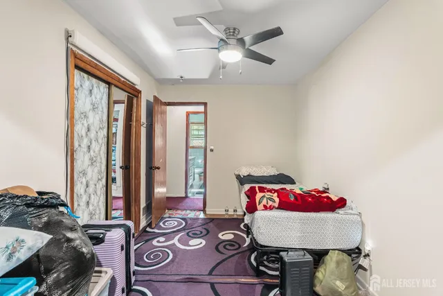 a living room with furniture and two large window