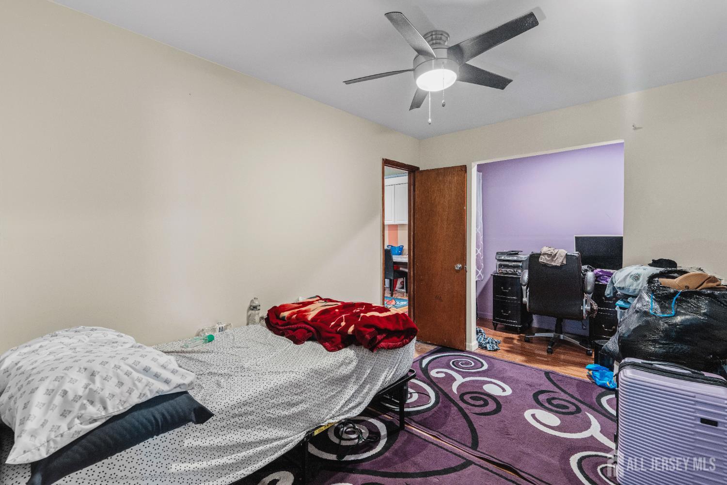 247 Adams Street Piscataway, NJ 08854 - Photo 17 of 49 a bedroom with a bed and a chandelier