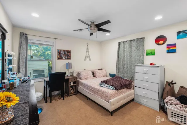 a bedroom with a bed and a desk