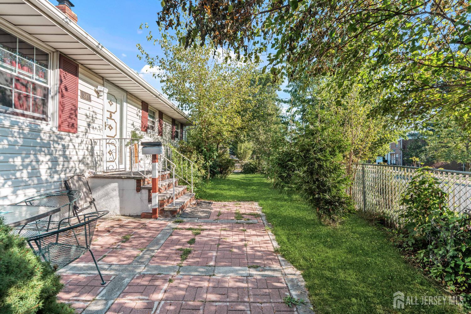 247 Adams Street Piscataway, NJ 08854 - Photo 2 of 49 a view of a yard with plants and large trees