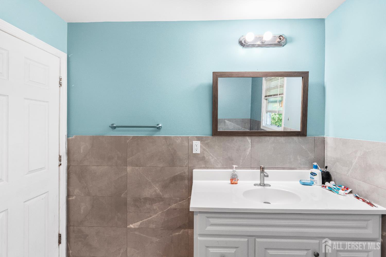 247 Adams Street Piscataway, NJ 08854 - Photo 24 of 49 a bathroom with a sink and a mirror