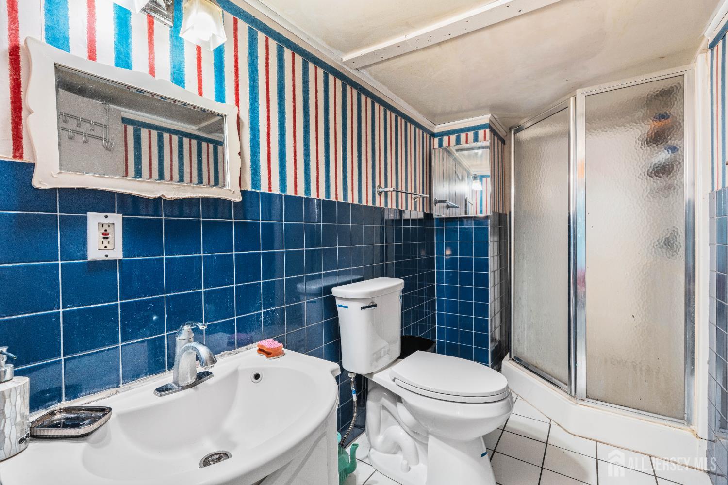 247 Adams Street Piscataway, NJ 08854 - Photo 27 of 49 a white toilet sitting next to a bathroom sink