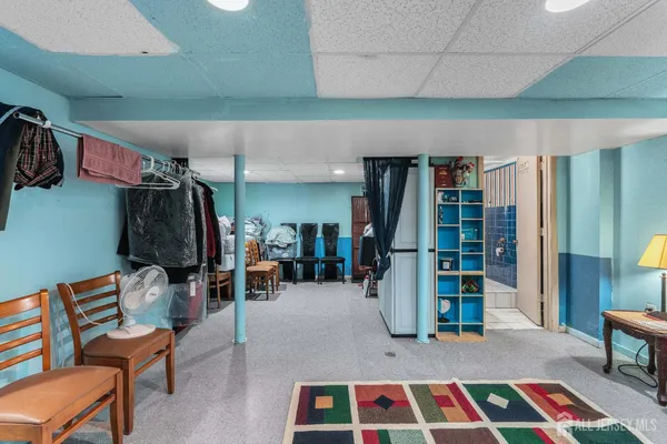 a view of a room with lots of furniture and white walls