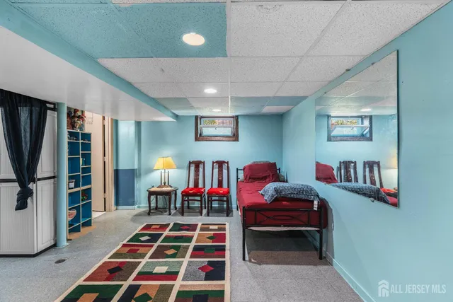 a bedroom with furniture and a book shelf