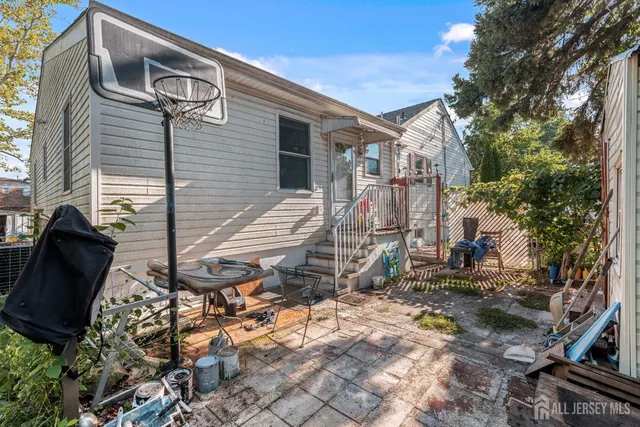 a view of a backyard with table and chairs and a fire pit