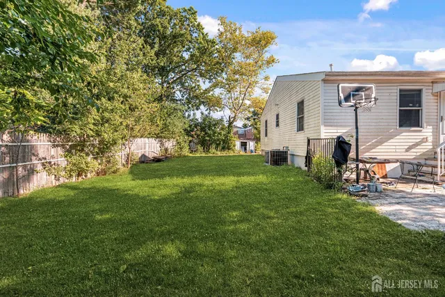 a aerial view of a house with yard and tree s