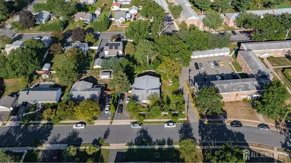 an aerial view of multiple houses with yard