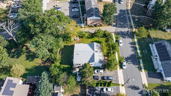 an aerial view of multiple houses with yard