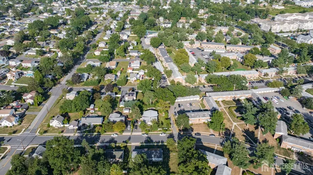 an aerial view of multiple houses with yard