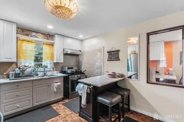 a kitchen with a sink stove and cabinets
