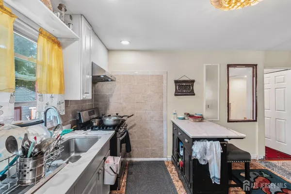 a kitchen with a sink stove and cabinets
