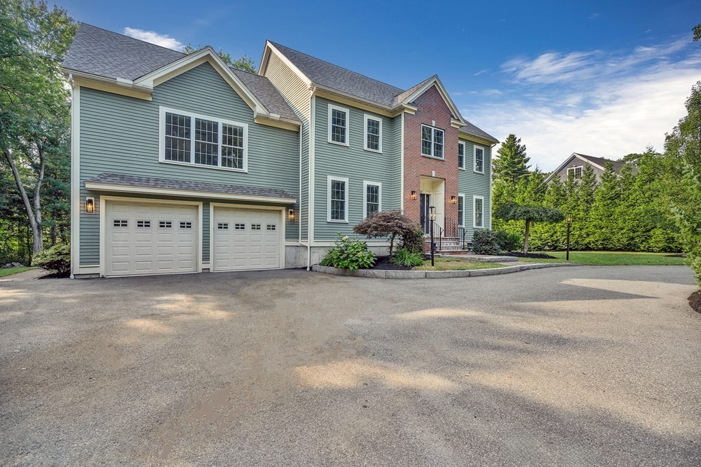 448 North Road Bedford, MA 01730 - Photo 1 of 22 a front view of a house with a yard and garage
