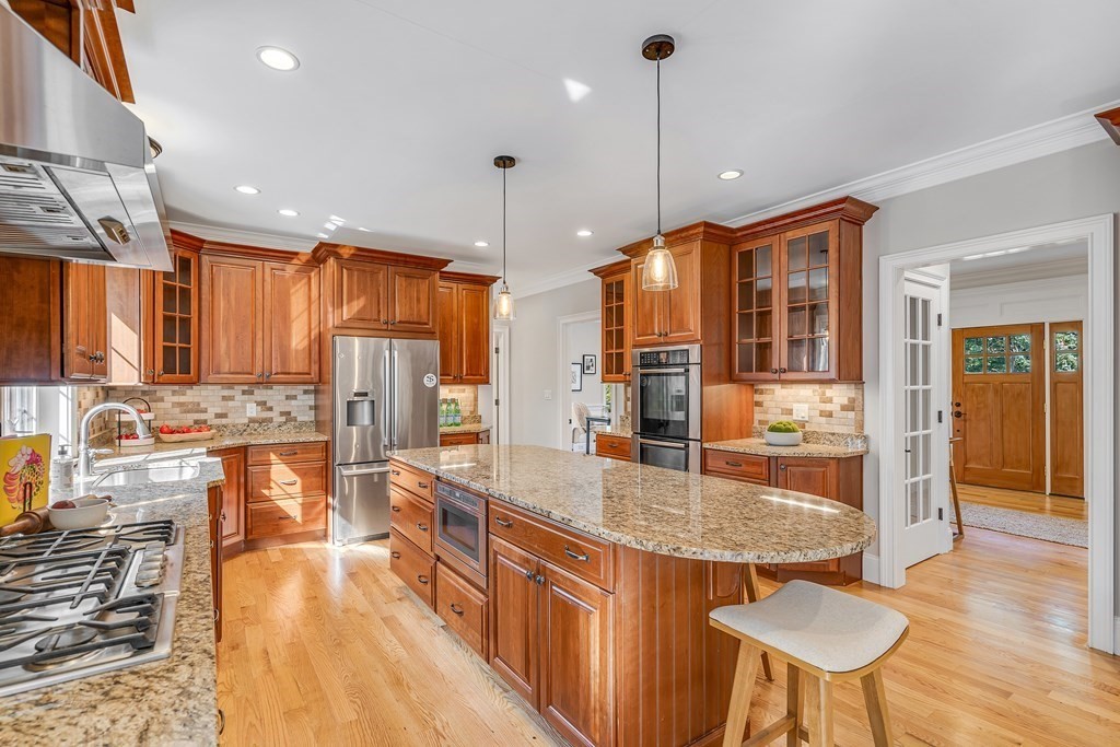 448 North Road Bedford, MA 01730 - Photo 6 of 22 a kitchen with stainless steel appliances granite countertop a stove a refrigerator a oven and a sink with granite countertops