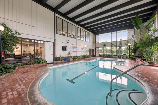 a swimming pool with outdoor seating and yard