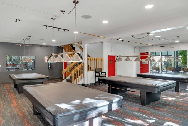 a room with lots of furniture and air hockey table