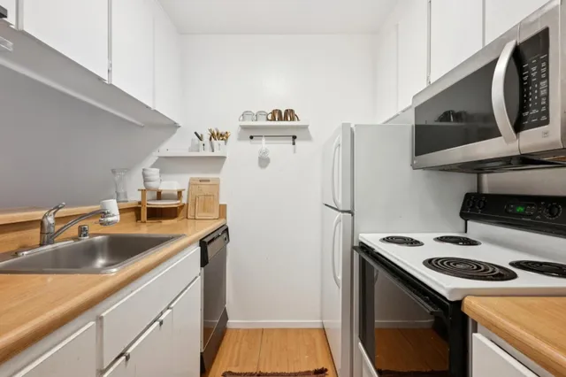 a kitchen with a sink a stove and a refrigerator