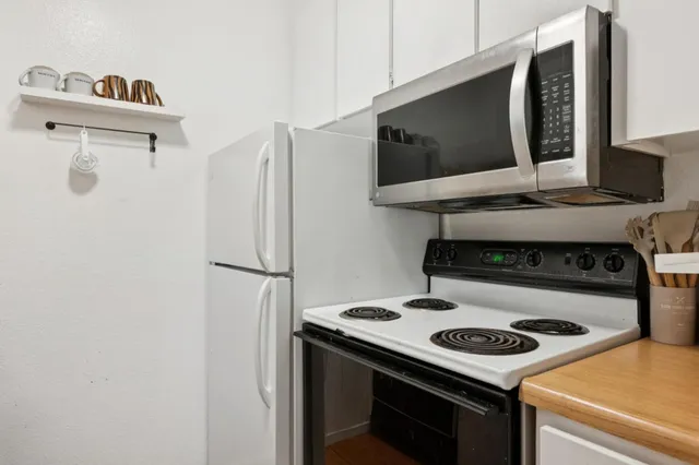 a kitchen with a stove and a microwave