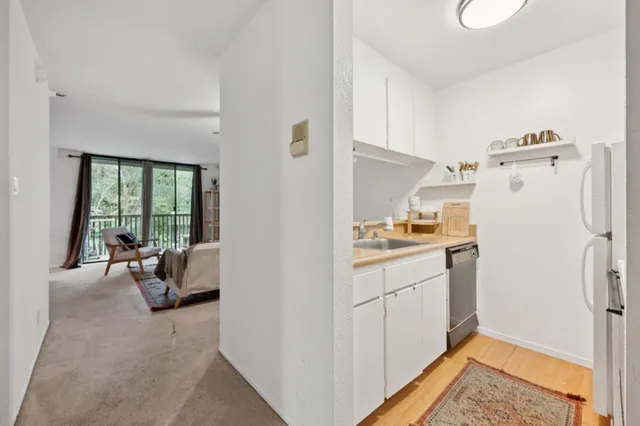 a kitchen with refrigerator and car parked