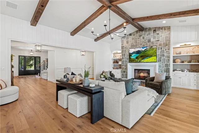 a living room with a bed furniture and a large window