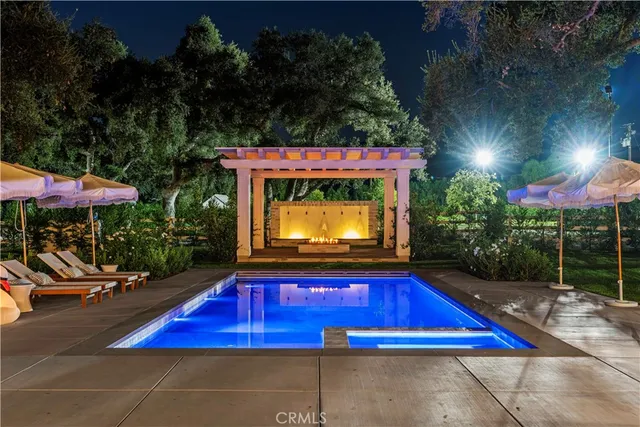 a view of a house with a yard and swimming pool