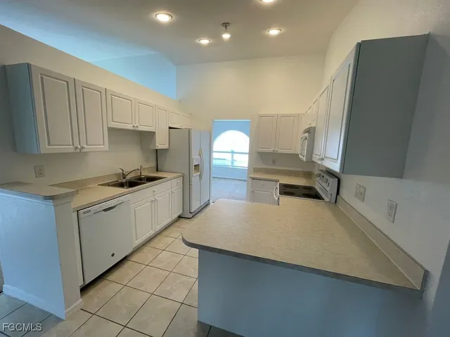 a kitchen with a sink cabinets and window