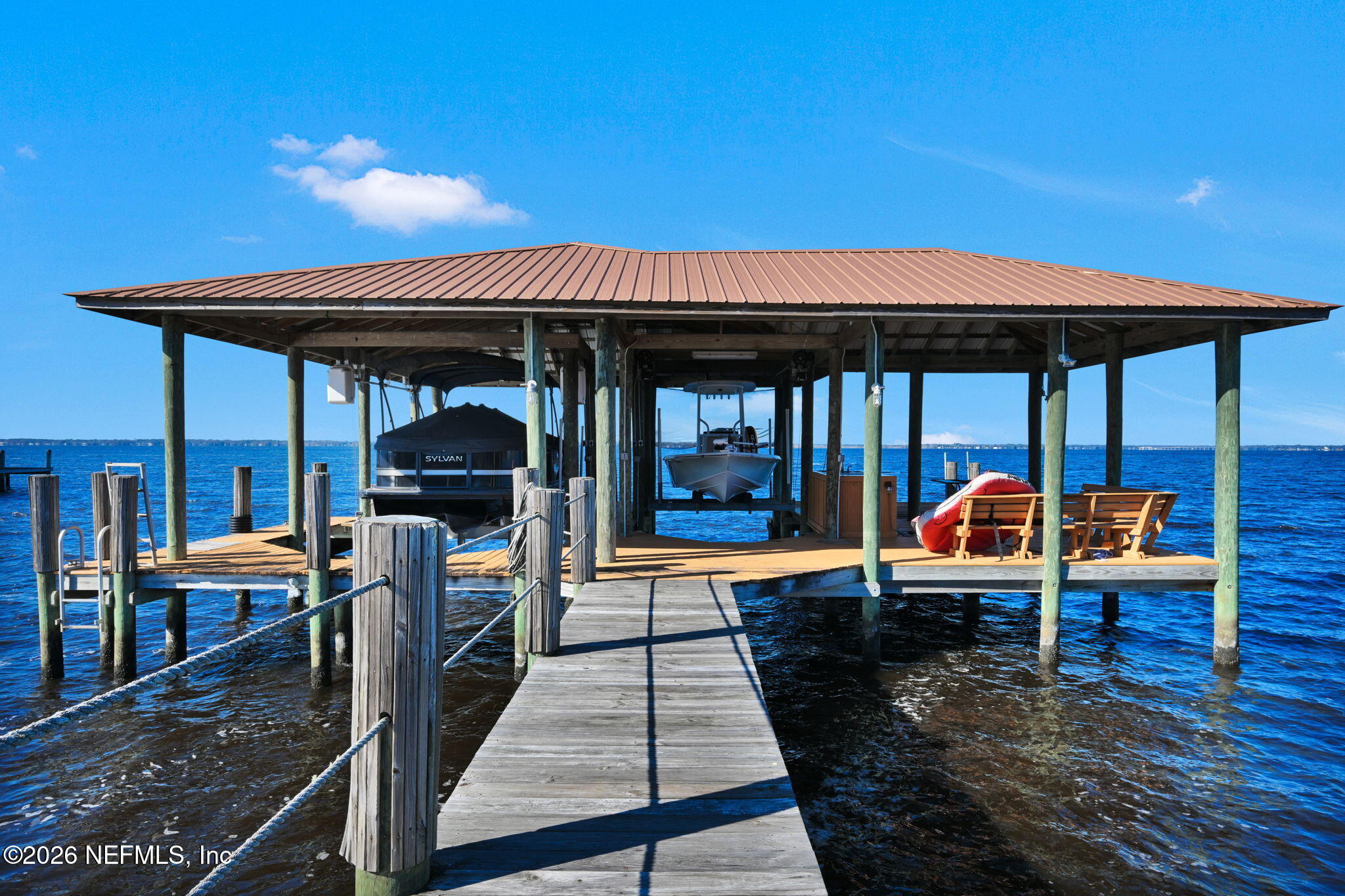 1050 Popolee Road St. Johns, FL 32259 - Photo 2 of 37 a view of a patio with table and chairs under an umbrella with wooden floor