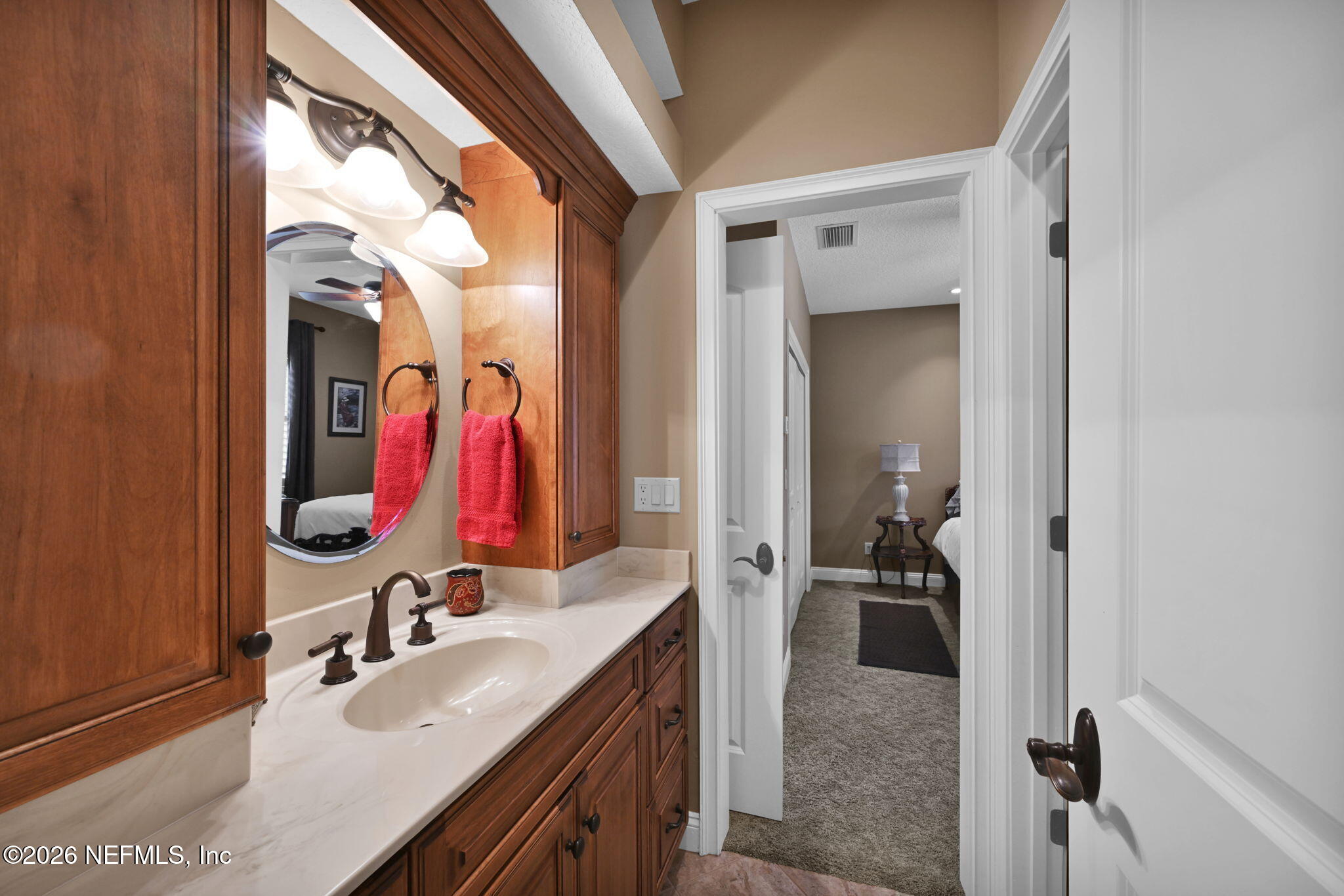 1050 Popolee Road St. Johns, FL 32259 - Photo 29 of 37 a bathroom with a sink vanity and mirror