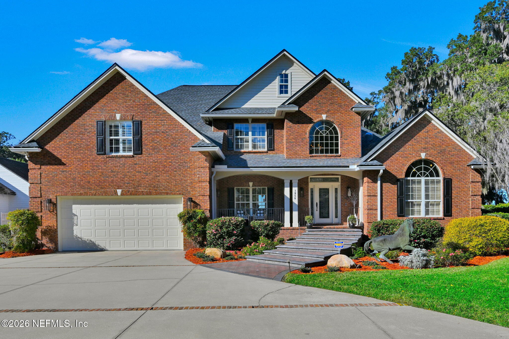 1050 Popolee Road St. Johns, FL 32259 - Photo 8 of 37 a front view of a house with a yard and potted plants