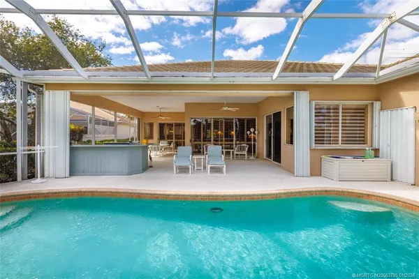 a view of a chairs and table in patio with a lake view