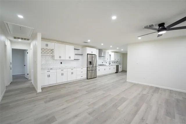 a view of a kitchen with wooden floor