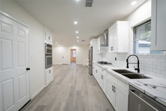 a kitchen with a sink stove and refrigerator