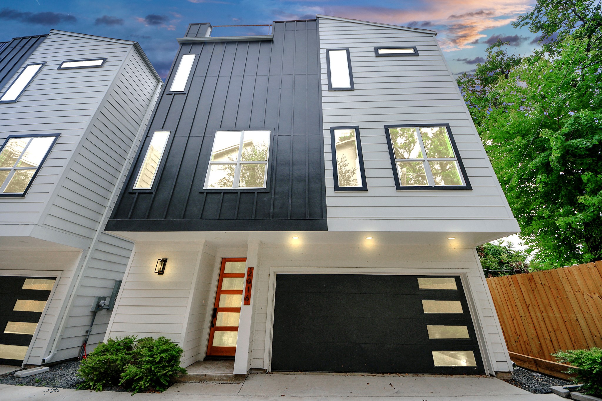 a front view of a house with a garden
