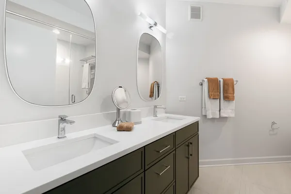 a bathroom with a double vanity sink and a mirror