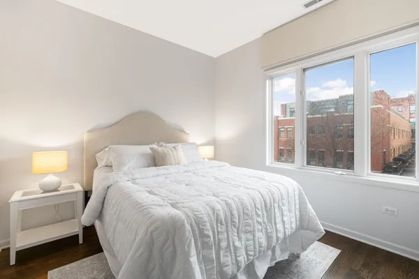 a bedroom with a bed and a large window