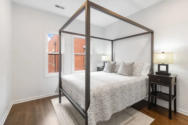 a bedroom with a bed lamp and a window