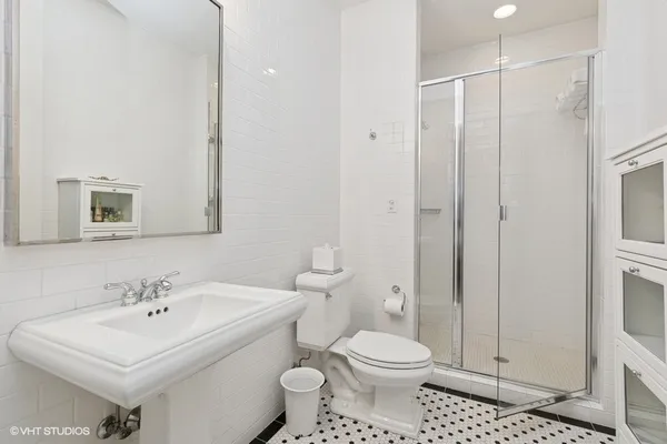 a bathroom with a sink toilet and shower