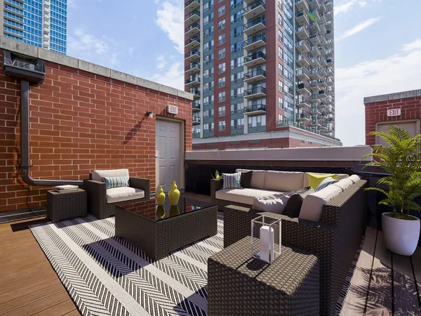a view of a patio with couches table and chairs and potted plants