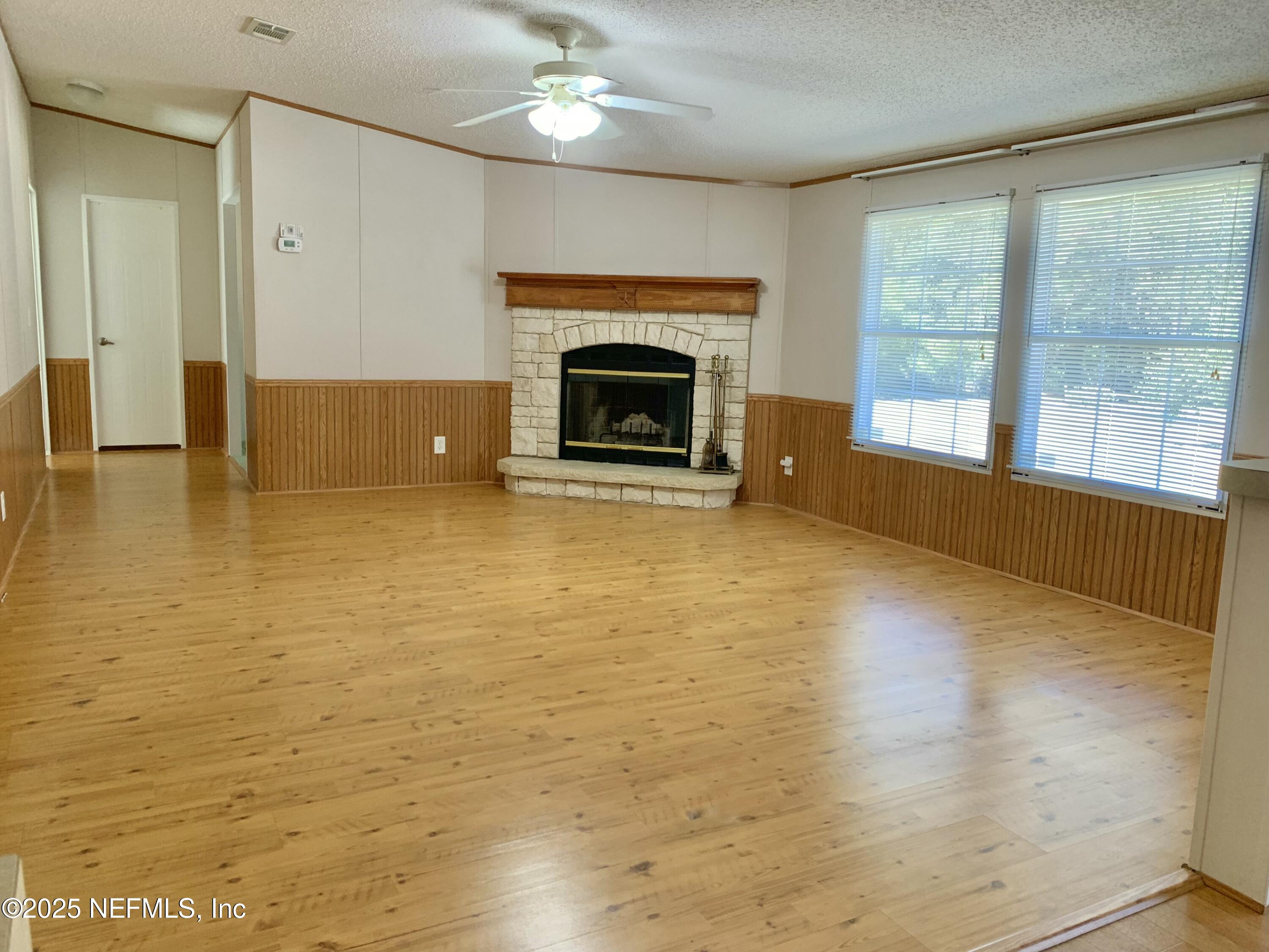 12752 Southeast 9th Place Gainesville, FL 32641 - Photo 18 of 53 a view of an empty room with a fireplace and a window